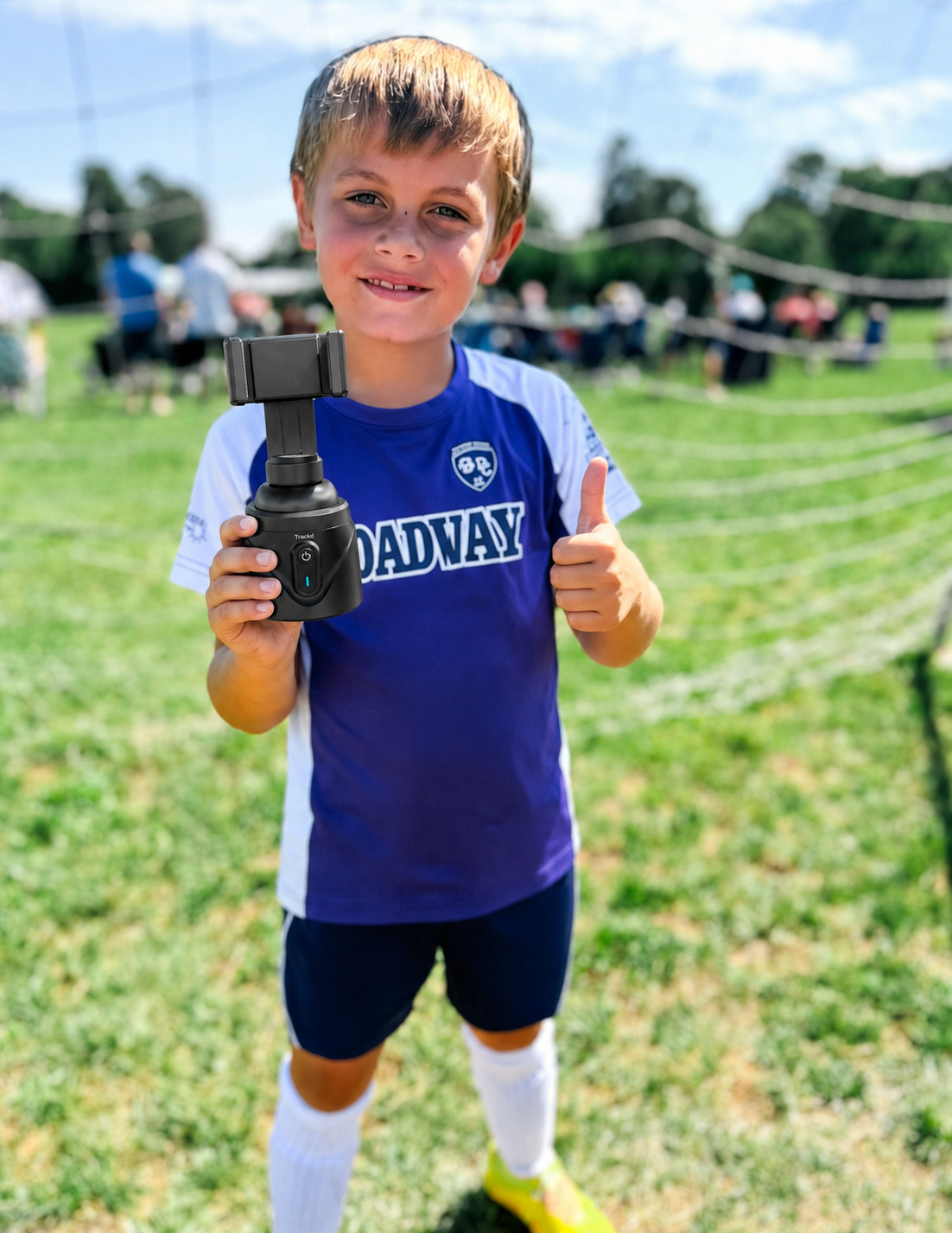 Youth soccer player holding a Trackd device